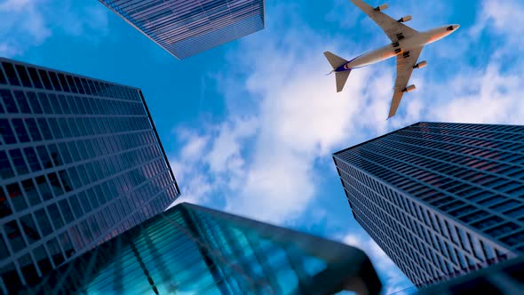 The Plane Flies Over The Buildings