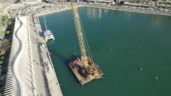 Aerial pan of Passeo del Muelle Dos pedestrian promenade; Malaga, Spain