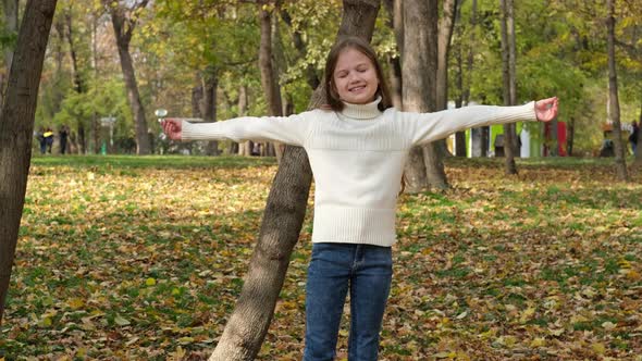 Little Girl Enjoying Autumn in City Park