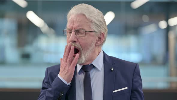 Portrait of Sleepy Old Businessman Yawning