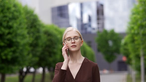 Serious Business Woman Talking on the Phone in the Street