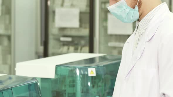 A Close-up and Smooth Transition of the Camera From the Head To the Hands of the Lab Technician