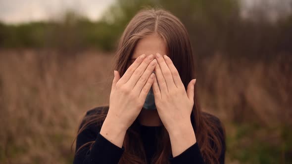 Woman in a Medical Mask Closes and Opens Face with Hands Pandemic Covid19 Coronavirus