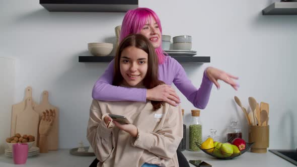 Lovely Woman with Physical Disability and Friend Enjoying Leisure in Kitchen