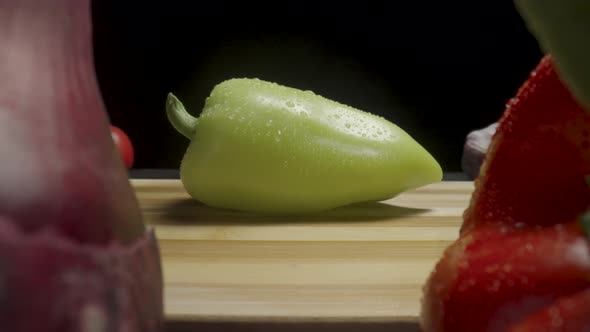 Red Yellow Sweet Pepper Red Onion Tomato and Garlic on a Wooden Board