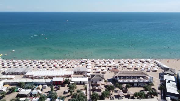 Sandy Beach with Umbrellas and Sun Loungers for Vacationers