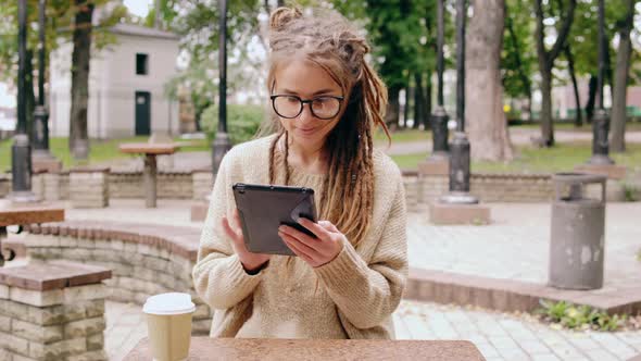 Smiling Hipster Girl Resting in Park