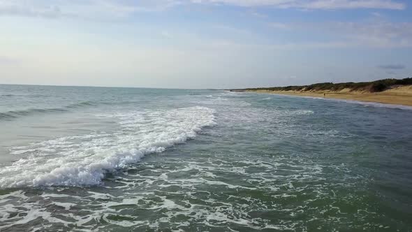 Sea Water Forming the Waves Touches the Shore. Aerial Survey