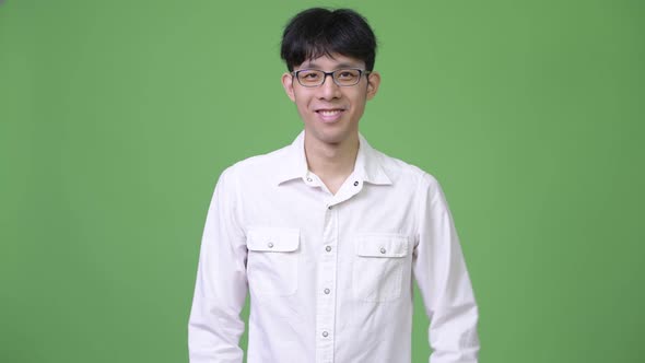 Young Happy Asian Businessman Smiling with Arms Crossed