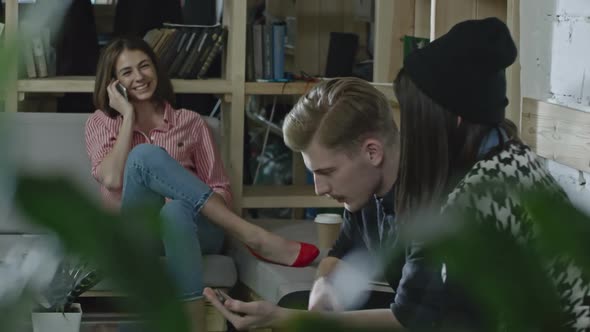 Colleagues Sitting on Couches in Modern Office and Talking