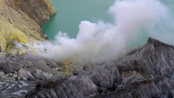 Kawah Ijen Volcano with Sulfur Smoke and Acidic Crater Lake 