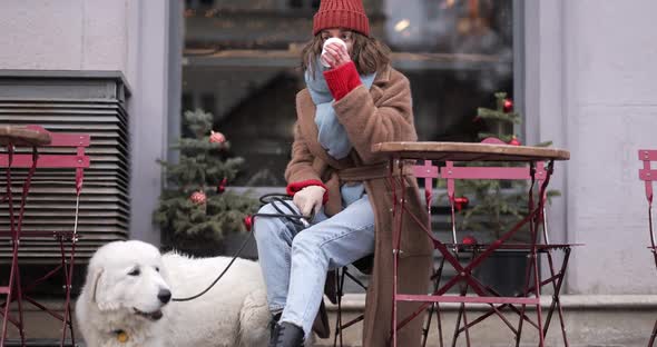 Woman with Her Dog at the Cafe in Winter