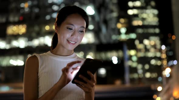 Woman using mobile phone in city 