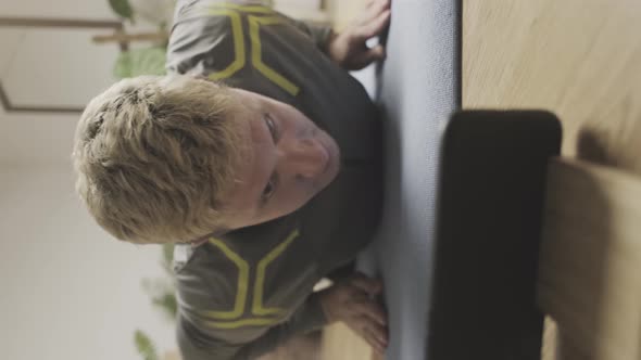 Young Man is Exercising at Online Lessons