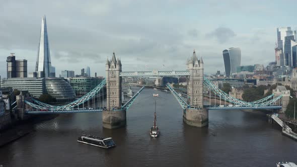 Aerial Daytime View to the Lifted Tower Bridge and Yacht Going Through It