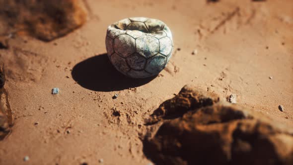 Old Football Ball on the Sand Beach alt