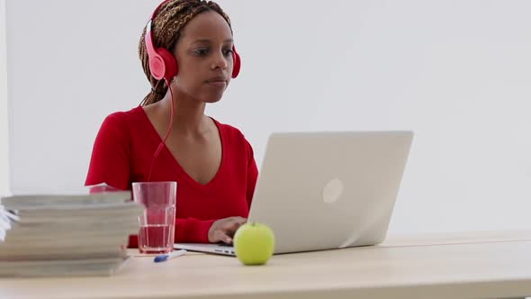 African American Female Student Typing and Studying Remotely at Desk with Laptop in Apartment Spbi