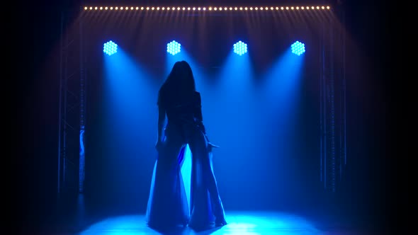 Silhouette Slender High Girl Dancing in a Sexy Suit in the Color of the English Flag and Rhinestones