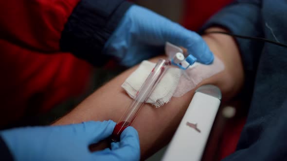 Paramedic Taking Sample for Blood Test