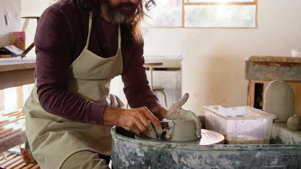 Male potter making pot