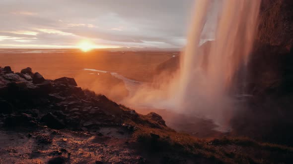 Slow motion shot of Seljalandsfoss at sunset, a famous waterfall in Iceland