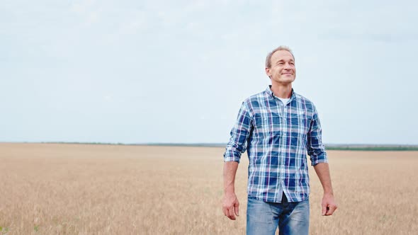 Attractive and Smiling Farmer Walking Through 