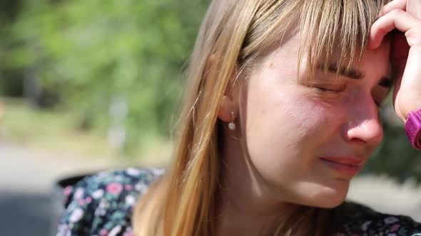 Sad Woman Crying on the Street in the Park