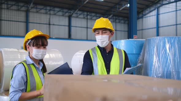 Warehouse workers man and woman check the product in workplace and discuss