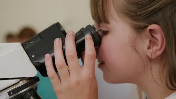 Girl using microscope