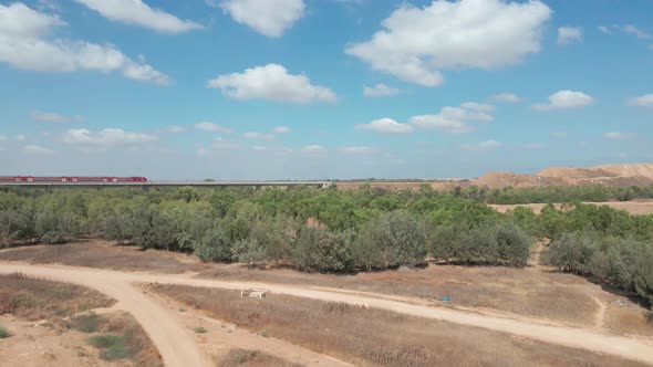 Train Crosses Green Field At Southern District City Netivot, Israel