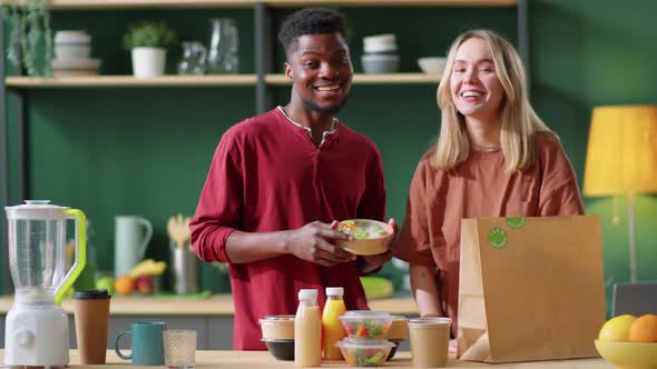 Portrait of Happy Multiethnic Couple with Healthy Food and Drinks