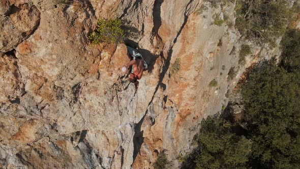 Slow Motion Back View Man Rockclimber Climbs on Overhanging Crag