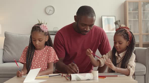 Father Drawing with Little Daughters