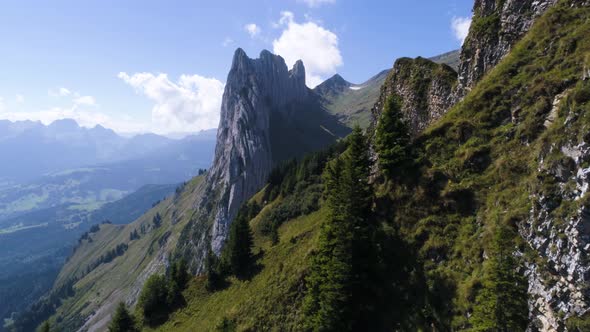 massive rock formation in the swiss alps, unique mountain at a sunny summer day with green meadow, s