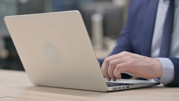 Hand Close Up of Businessman Typing on Laptop
