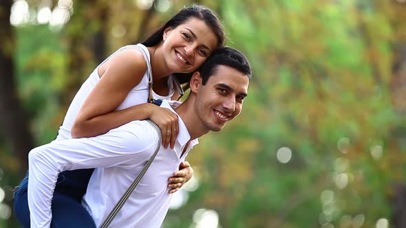 Teen couple hugging in the park in autumn time