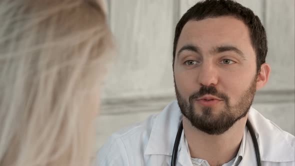 Young Doctor with Good News To His Patient on a Green Screen, Chroma Key