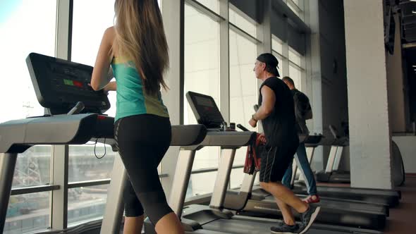 Slowmotion Footage of Three Athletes in Front of Panoramic Windows