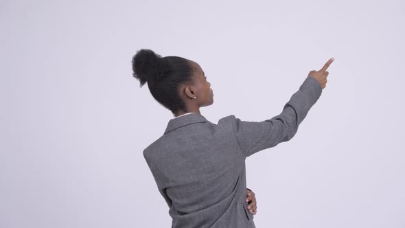 Rear View of Young African Businesswoman Directing and Pointing Finger
