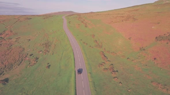 Car driving in Dartmoor National Park, Devon, England, UK. Aerial drone view