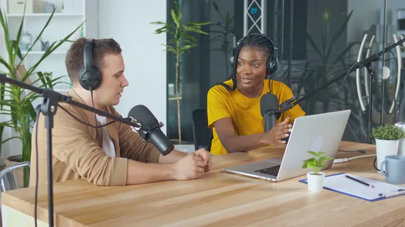 Confident African American Woman With White Man Hosting a Podcast