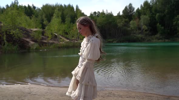 Lonely Beautiful Woman Is Walking on Coast of Lake in Forest, Romantic Nature