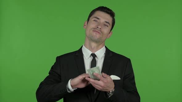 Cheerful Young Businessman Throwing Money Away Chroma Key