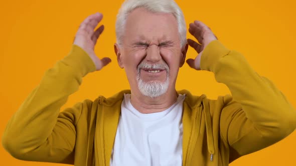 Aged Pensioner Covering Ears Suffering Loud Noise, Conversation Nervousness