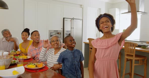 Multi-generation family taking selfie with mobile phone at home 4k