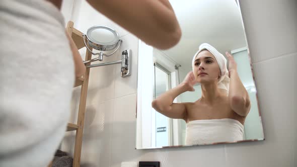 Beautiful Woman After Shower Looking In Mirror At Bathroom