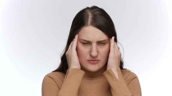 Portrait of Young Woman Suffering From Headache Rubbing Her Head with Hands