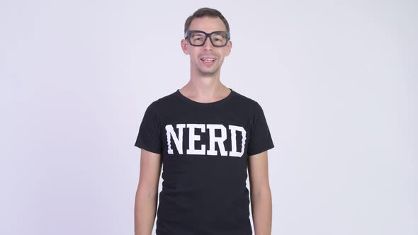 Studio Shot of Happy Nerd Man Smiling While Wearing Eyeglasses