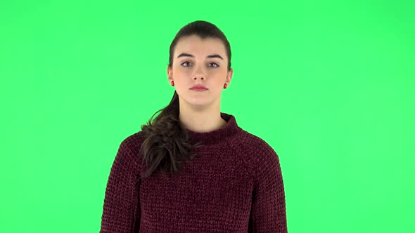 Girl Stands and Looks Forward and Is Suddenly Scared. Green Screen