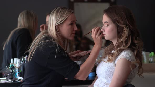 Makeup Artist Paints the Eyes of a Girl Model